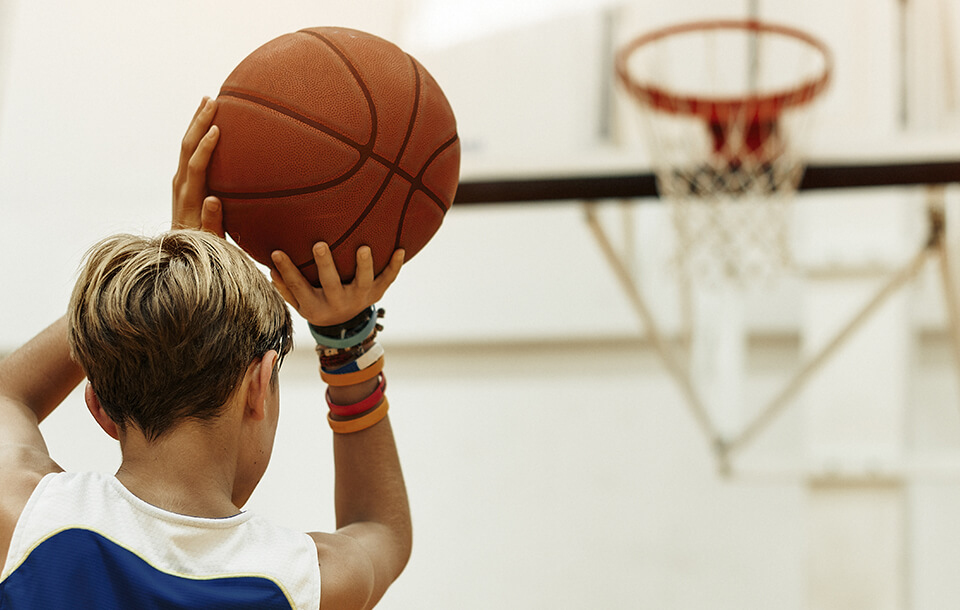 boy shooting baskets